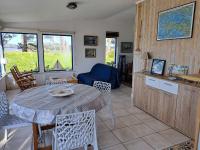 a kitchen and living room with a table and chairs at Holiday home in a secluded location surrounded by the sea, Hanvec in Hanvec