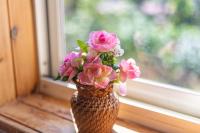 a vase filled with pink flowers sitting on a window sill at Yishin Garden B&amp;B in Pinghe