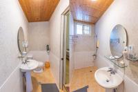 a bathroom with two sinks and a shower at Yishin Garden B&amp;B in Pinghe