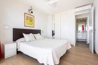 A bed or beds in a room at BEACHFRONT -- NEW LUXURY Apartment -- 1ª Linea Playa -- Fuengirola CITY CENTER -- Private PARKING -- Panoramic Sea Views --