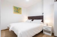 A bed or beds in a room at BEACHFRONT -- NEW LUXURY Apartment -- 1ª Linea Playa -- Fuengirola CITY CENTER -- Private PARKING -- Panoramic Sea Views --