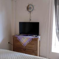 Televízia a/alebo spoločenská miestnosť v ubytovaní Small and cosy appartment- Piccolina