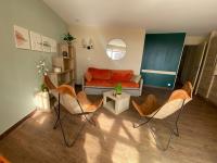 a living room with an orange couch and chairs at Appartement Saint-Raphaël, 3 pièces, 6 personnes - FR-1-504-658 in Saint-Raphaël