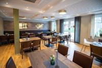 ein Esszimmer mit Holztischen und Stühlen in der Unterkunft Gästehaus am Tiergarten in Raesfeld