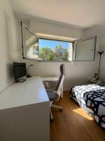 a bedroom with a desk and a bed and a window at Superbe Appartement, Cap d&#39;Antibes - Clim, Parking, Terrasse vue mer in Antibes
