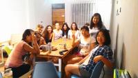 a group of people sitting around a table at Bayhouse Comfortel Hualien Hostel in Hualien City