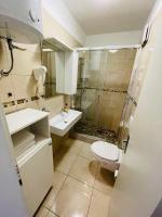 a bathroom with a toilet and a sink and a shower at Apartments Lavanda 1 in Njivice