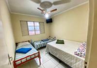 a bedroom with two beds and a ceiling fan at Casarão Hostel in Guaratinguetá