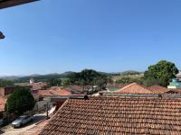 a view from the roof of a town with red tile roofs at Casarão Hostel in Guaratinguetá