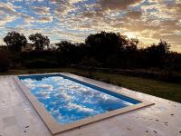 a swimming pool with clouds in the sky at Villa Yucca Istra in Labin