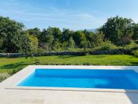 a swimming pool in a yard with a garden at Villa Yucca Istra in Labin