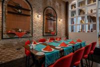a dining room with a table and red chairs at Sunland Resort Beldibi in Beldibi