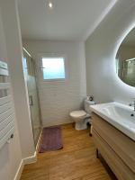 a bathroom with a toilet and a sink and a mirror at Villa MA&amp;VA in Lacanau-Océan