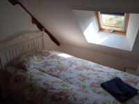 A bed or beds in a room at Tranquillity Cottage