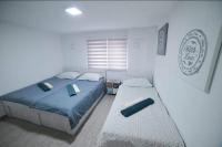 a bedroom with two beds and a window at Hostel Tuzla in Tuzla