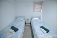 two beds in a small room with sidx sidx sidx at Hostel Tuzla in Tuzla