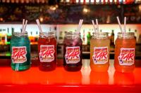 a group of drinks in jars on a shelf at Nomads St Kilda in Melbourne