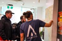 a group of people looking at a map at Nomads St Kilda in Melbourne