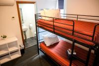 a couple of bunk beds in a room with a mirror at Nomads St Kilda in Melbourne