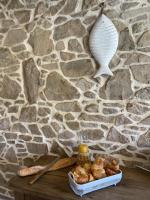 a table with bread and a shell on a stone wall at Les Petites Maisons de la Clarté in Perros-Guirec