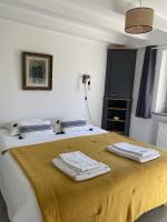 a bedroom with a bed with two towels on it at Les Petites Maisons de la Clarté in Perros-Guirec