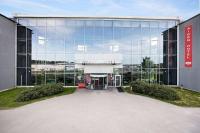 a large glass building with an airport sign on it at Aiden by Best Western Skavsta Airport in Nyköping
