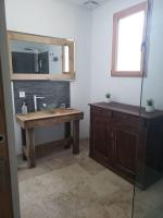 a bathroom with a sink and a mirror at Maison du mur jaune in Tourtoirac