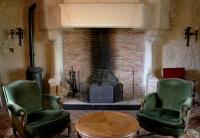 a living room with two chairs and a fireplace at Manoir de Pimelles-Bourgogne-Chablis-2h15 Paris 