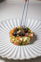 a bowl of food on a white plate with two utensils at Warsaw Presidential Hotel in Warsaw
