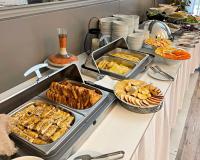 a buffet with many trays of food on a table at Arena Grand Hotel in Quba
