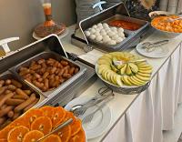 a buffet with many different types of food on a table at Arena Grand Hotel in Quba