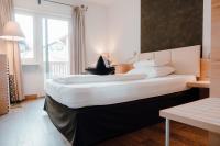 A bed or beds in a room at Residence Hotel Alpinum