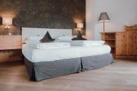 A bed or beds in a room at Residence Hotel Alpinum