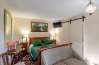 a bedroom with a bed with green pillows at Gîtes et chambres croix du sud in Saint-Amand-de-Vergt