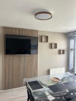 Televízia a/alebo spoločenská miestnosť v ubytovaní Appartement 2 pièces à Cabourg