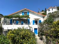 a white house with blue doors and flowers at FLC-Sea View-Jacuzzi-3 Bedrooms-8p-Parking for 2 cars in Marseille