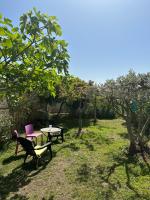 two chairs and a table in a yard with trees at FLC-Sea View-Jacuzzi-3 Bedrooms-8p-Parking for 2 cars in Marseille