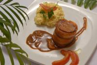 a plate of food with meat and mashed potatoes and gravy at Angra Boutique Hotel in Angra dos Reis