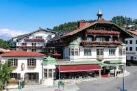 a large building with a clock tower on top of it at Sporthotel Igls in Innsbruck