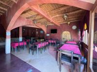 a dining room with pink tables and chairs at Palais D'Ouzoud in Azilal