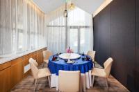a dining room with a blue table and chairs at Jinshanling Great Wall Hotel in Chengde