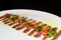 a plate of food with meat and vegetables on it at Alva Valley Hotel in Oliveira do Hospital