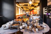 a table with a bunch of food on it at TRIBE Riga City Centre in Rīga