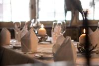 a table with candles and wine glasses on it at Sporthotel Igls in Innsbruck