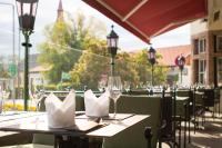 a table with wine glasses and napkins on a patio at Sporthotel Igls in Innsbruck