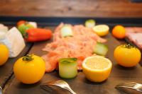 a table topped with oranges and vegetables and spoons at Sporthotel Igls in Innsbruck