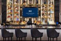 eine Bar in einem Restaurant mit Stühlen und einem TV in der Unterkunft Fontainebleau Las Vegas in Las Vegas