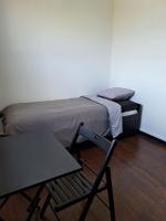 a room with a bed and a chair and a table at Chambre Solo Duo 20 min Paris - G in Drancy