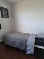 a bedroom with a bed and a picture on the wall at Chambre Solo Duo 20 min Paris - G in Drancy