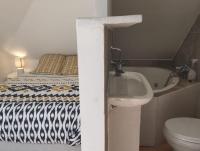 a bathroom with a bed and a sink and a tub at CASA COLIVING avec chambre salle de bain individuelles privatives in Saint-Pierre